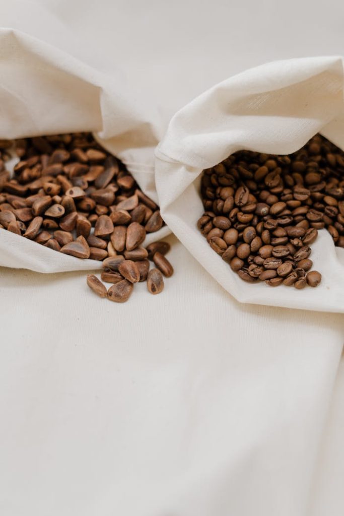 Organic coffee beans displayed in natural cloth bags, emphasizing sustainability.